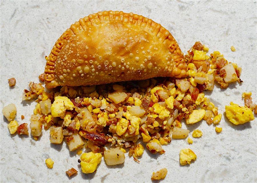 Breakfast empanada filled with potatoes, bacon and cheese
