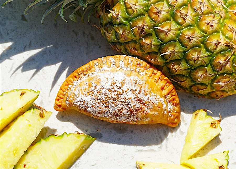 Pineapple empanada dusted with powdered sugar and cinnamon